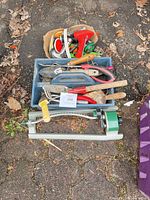 Entire lot showing tote with hand tools and sprinkler