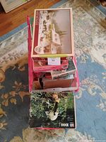 Top view of crate showing winter scene puzzle and stack of assorted boxes