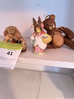 Front view of three figurines on shelf