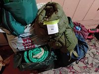 Stack of rolled sleeping bags showing colors and storage bags