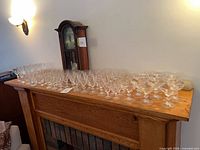 Full set of clear glassware arranged on mantle