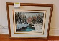 Front view of framed winter landscape painting showing image, mat and frame
