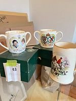 Both the Crown Staffordshire loving cup and Sadler tankard displayed on table