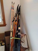 Two pairs skis, multiple poles bundled