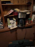 Front view of Cuisinart coffee maker, boxed kettle, carafe visible