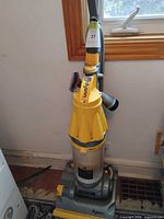 Full view of Dyson upright vacuum, hose and wand visible