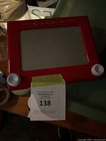 Front view showing full Etch A Sketch with screen and knobs