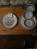 Stacks of Festival dinner plates and bowls on table showing pattern and rim detail
