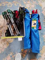 Basket of five folded chairs showing aluminum frames and mixed fabric colours
