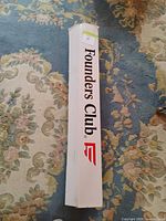 Closed white box labeled Founders Club