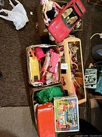 Overview of boxes containing Barbie dolls, red car, camper van and Pool Party box