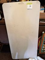 Front view of rectangular white plastic folding table