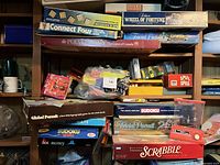 Stacked board game boxes showing titles and wear