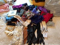 Overview of lot showing scarves, long gloves, packaged gloves, bow ties