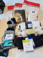 All packaged and tagged socks and tights laid out on bed