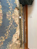 Full view of disassembled adjustable metal bed rails on rug