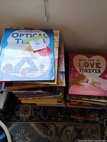 Top of left stack showing Optical Tricks book