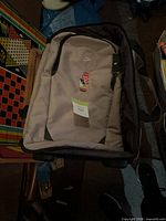 Front view of beige Nike suitcase