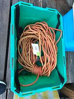 Coiled orange 12/3 extension cord in tote
