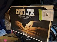 Front of Ouija Mystifying Oracle box displaying artwork and branding