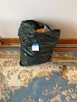 Closed black bag of plush toys