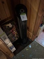 Full view of black Seville Classics tower fan standing upright