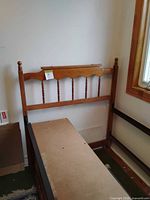 Headboard with turned spindles attached to bed frame