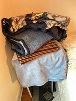 Stacked view showing both blankets: wolf print on top, blue beneath