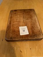 Top view of rectangular butcher block showing knife marks and thickness