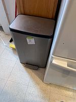 Front view showing stainless body, foot pedal, scratches