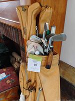 full view of tan leather bag with clubs and headcovers