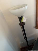 Full view of torchiere lamp with glass shade