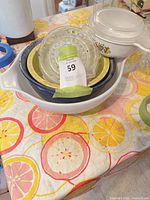 Stacked view showing Pyrex bowl, two ceramic bowls, glass juicer, casserole lid