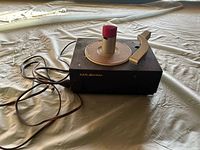 Top view of RCA Victor 45 RPM record player showing tonearm, spindle and power cord