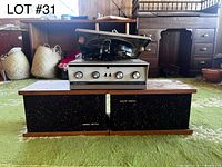 Front view of turntable mounted on receiver with two matching speakers