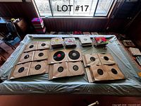 Overview of table showing sleeved records, loose discs, and picture-sleeve stack