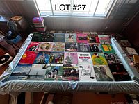 Overview of 31 vinyl records laid out on table showing front jackets