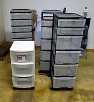 group shot showing three black drawer towers and one white drawer unit