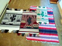 All four blankets laid out showing sizes, patterns, colors, fringe