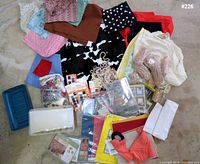 Spread of all craft items showing fabrics, wax, beads, thread, papers, tools and storage boxes
