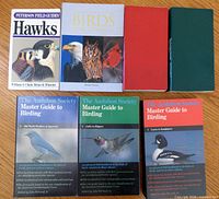 All eight books laid out front covers visible