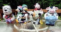 Group view of four ceramic animal cookie jars on glass table