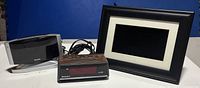 Front view showing Sharp alarm clock radio, Westclox alarm clock, and digital picture frame