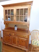 Front view of the pine two-piece hutch showing upper glass doors, lower drawers and doors