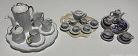 All three miniature tea sets side by side showing components