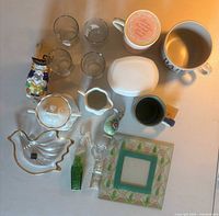 Overview of lot showing mugs, tumblers, lidded dish, decorative glass pieces