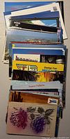 Stack of assorted postcards showing varied fronts
