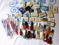 overall view of toothbrushes, soap bars and nail polish collection on towel