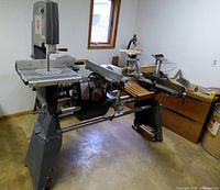 Full view of ShopSmith Mark V on tubular base with bandsaw and scroll saw attachments installed
