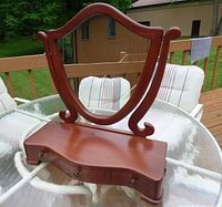 Front view of vanity showing mirror frame, base and overall form